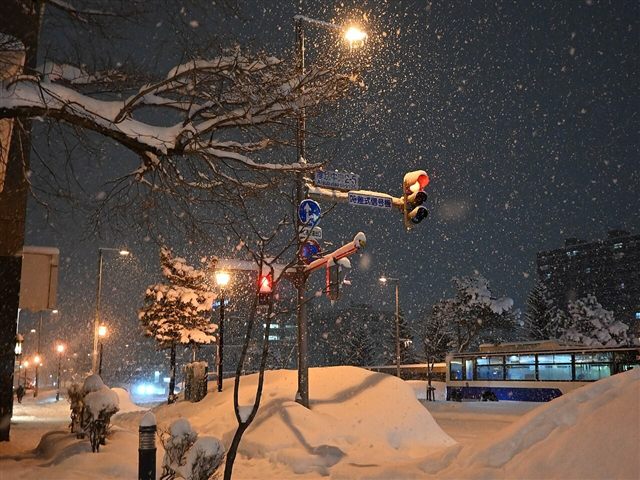 雪が降り積もった札幌の夜の交差点